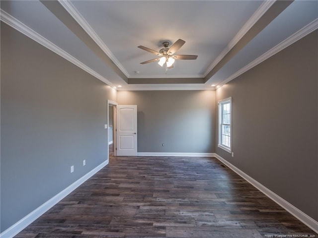 831 Norment Rd, Lumberton, NC 28360 - empty room with crown molding, dark wood-style flooring, ceiling fan, baseboards, and a tray ceiling