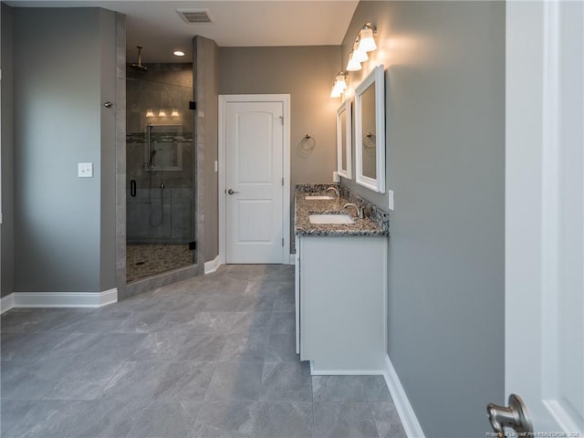831 Norment Rd, Lumberton, NC 28360 - full bathroom with double vanity, visible vents, a stall shower, a sink, and baseboards