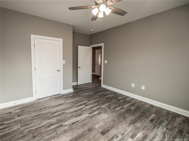831 Norment Rd, Lumberton, NC 28360 - spare room with dark wood-type flooring, a ceiling fan, and baseboards