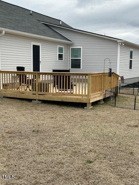 back of house with a wooden deck