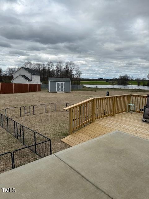 view of yard with a patio area, a deck, and a shed