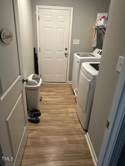 laundry area featuring independent washer and dryer and light wood-type flooring