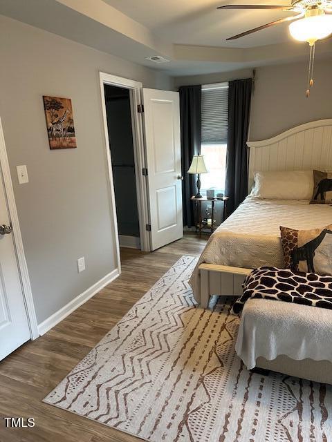 bedroom with hardwood / wood-style flooring and ceiling fan