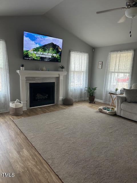 unfurnished living room with hardwood / wood-style floors, plenty of natural light, and ceiling fan