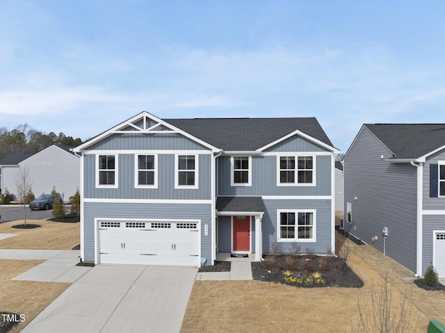 view of front of property featuring a garage and a front lawn