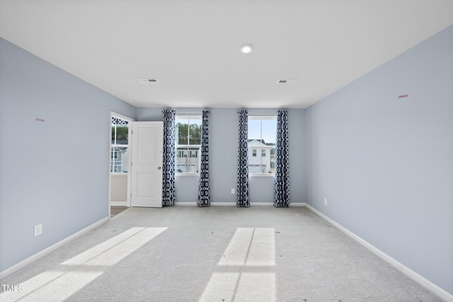 unfurnished room featuring light colored carpet