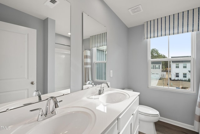 bathroom with vanity, hardwood / wood-style flooring, a shower with curtain, and toilet