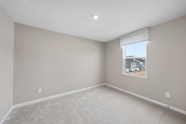 empty room featuring light carpet