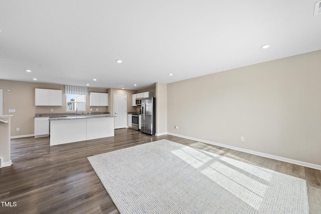 unfurnished living room featuring dark hardwood / wood-style floors