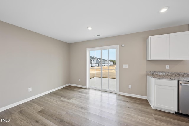 unfurnished dining area with light wood-type flooring