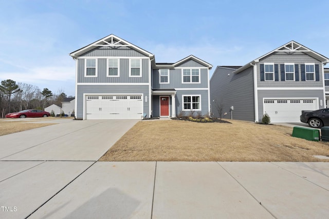 craftsman inspired home featuring a garage and a front lawn