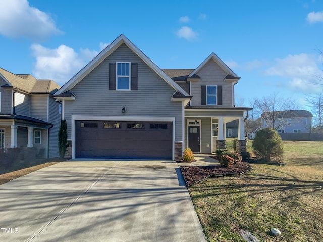 view of front of home featuring a front yard and a garage