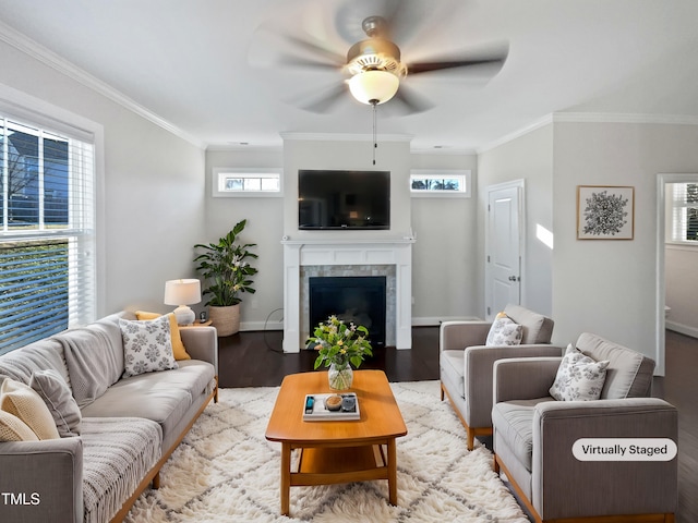 living room with ornamental molding, light wood-type flooring, and a fireplace