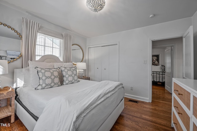 bedroom featuring a closet and dark hardwood / wood-style floors