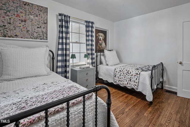 bedroom featuring dark wood-type flooring