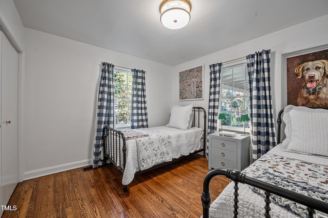 bedroom with dark hardwood / wood-style flooring