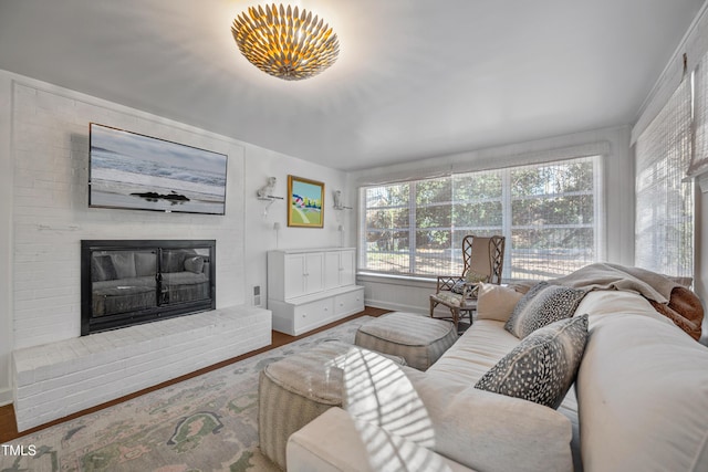 living room featuring a brick fireplace and wood-type flooring