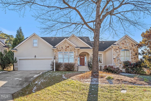 view of front of house featuring a front yard and a garage