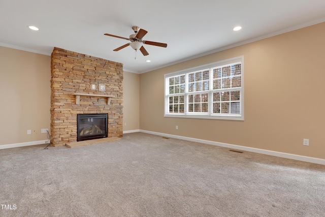 unfurnished living room featuring carpet floors, a fireplace, ornamental molding, and ceiling fan