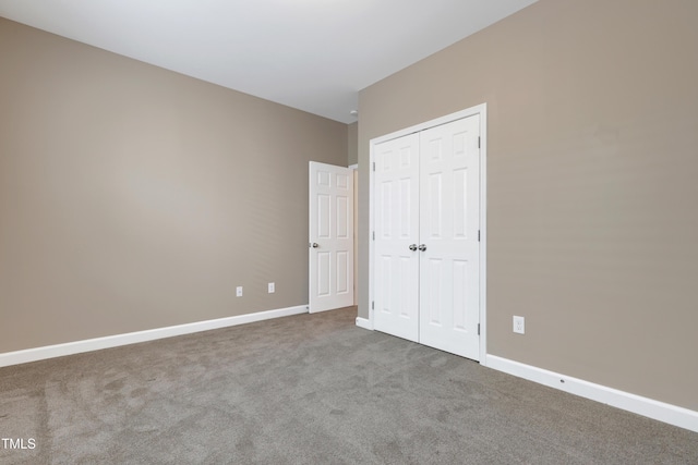 unfurnished bedroom featuring carpet floors and a closet