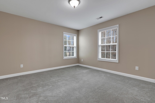 empty room featuring light colored carpet