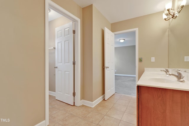 bathroom featuring tile patterned flooring, vanity, and an inviting chandelier