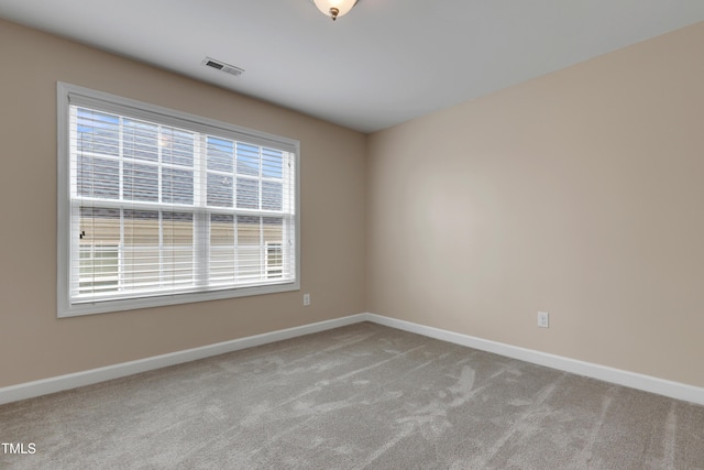 unfurnished room with light colored carpet