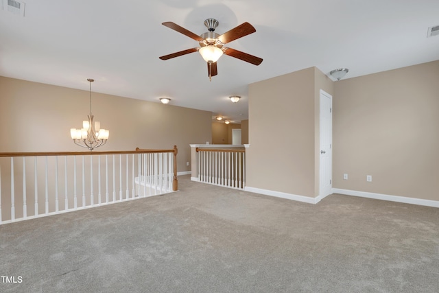 empty room featuring carpet and a notable chandelier