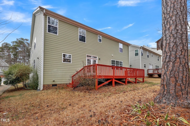 rear view of house featuring a wooden deck