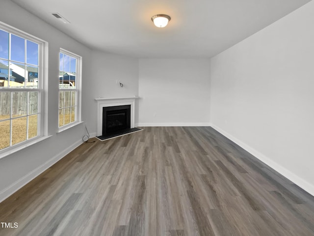 unfurnished living room with wood-type flooring