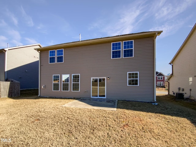 rear view of property featuring a lawn, a patio area, and cooling unit