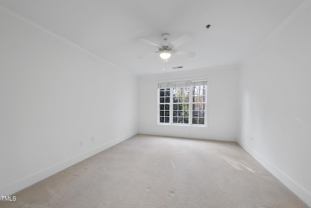 empty room with crown molding, carpet floors, and ceiling fan