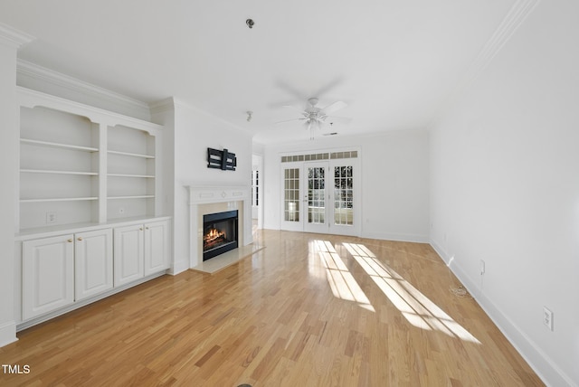 unfurnished living room with ceiling fan, french doors, and crown molding