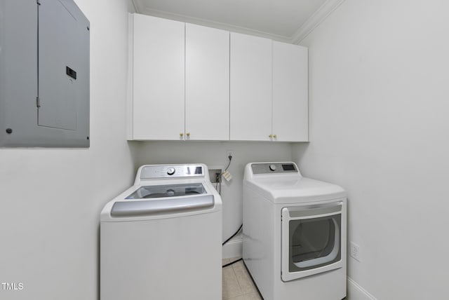 washroom with washing machine and dryer, electric panel, cabinets, light tile patterned floors, and crown molding