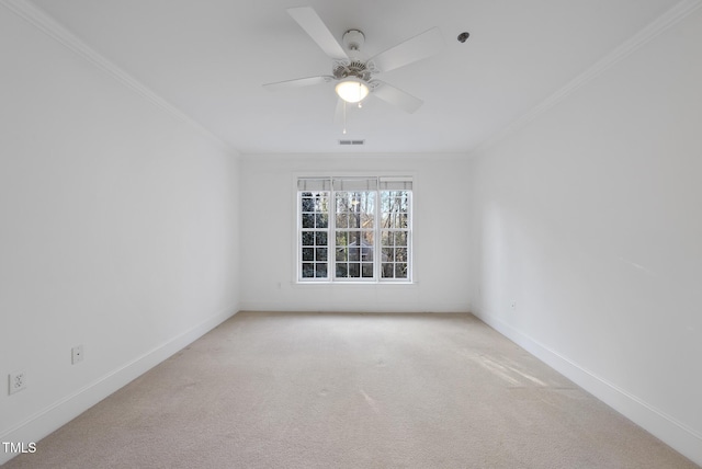 carpeted spare room featuring ceiling fan and crown molding