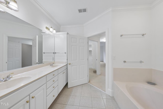 bathroom featuring tile patterned floors, a tub, ornamental molding, and vanity