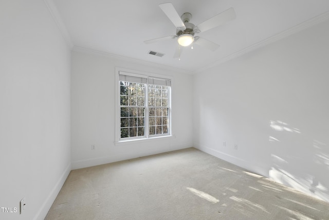 empty room with ceiling fan, light carpet, and crown molding