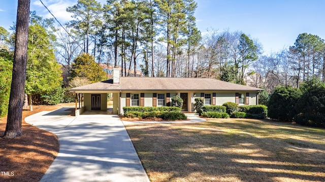 ranch-style home featuring a carport and a front yard