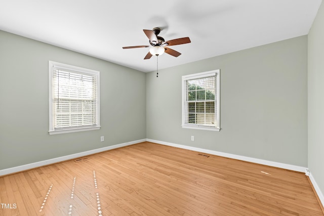 empty room featuring ceiling fan and light wood-type flooring