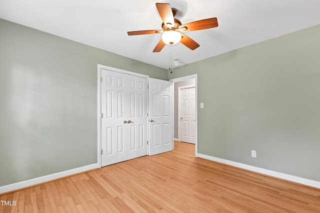 unfurnished bedroom featuring light hardwood / wood-style floors, a closet, and ceiling fan