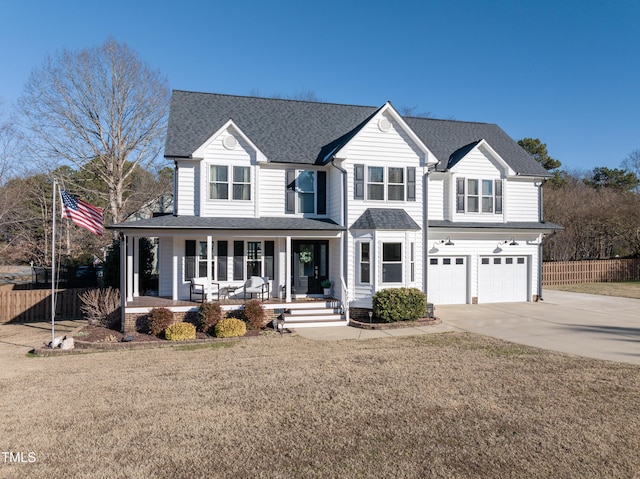 view of front facade with a front lawn, a garage, and a porch