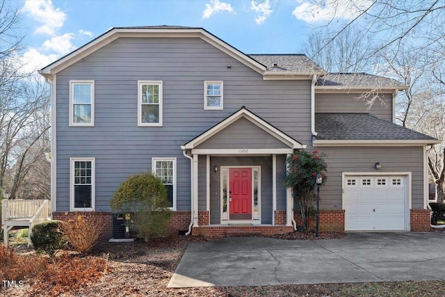 view of front of property with a garage and central AC unit