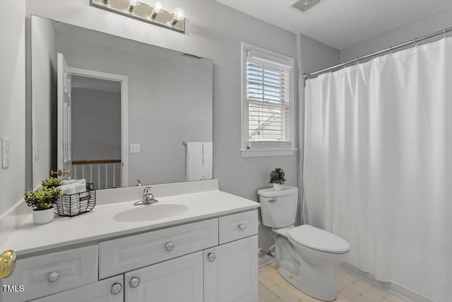 bathroom with toilet and vanity