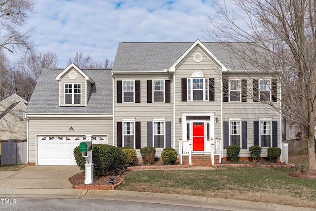 colonial home with a front lawn and a garage