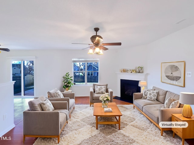 living room featuring hardwood / wood-style flooring and ceiling fan