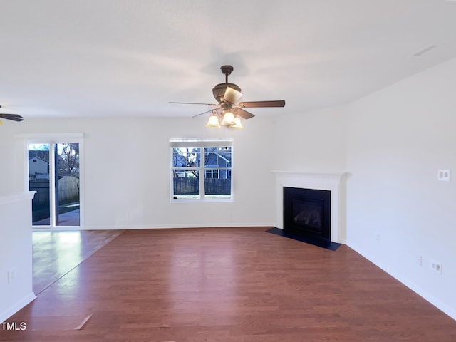 unfurnished living room with ceiling fan and dark hardwood / wood-style floors