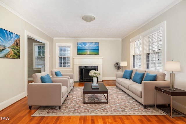 living room featuring a brick fireplace, hardwood / wood-style flooring, and ornamental molding