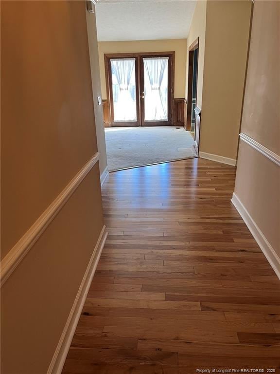 hall featuring french doors and hardwood / wood-style floors