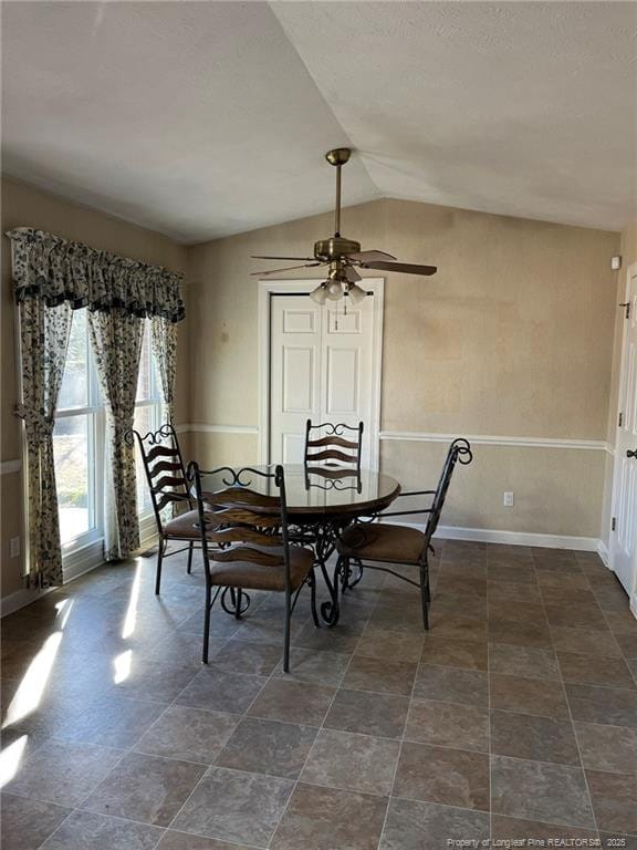 dining room featuring ceiling fan and vaulted ceiling