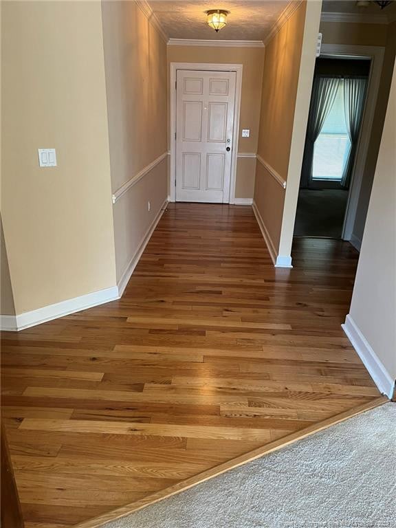 interior space with ornamental molding and wood-type flooring